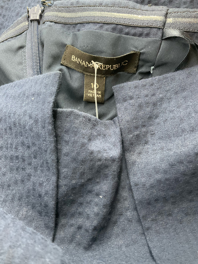 Close-up of Banana Republic label inside navy strapless dress, size 10, confirming brand authenticity and pre-owned condition.