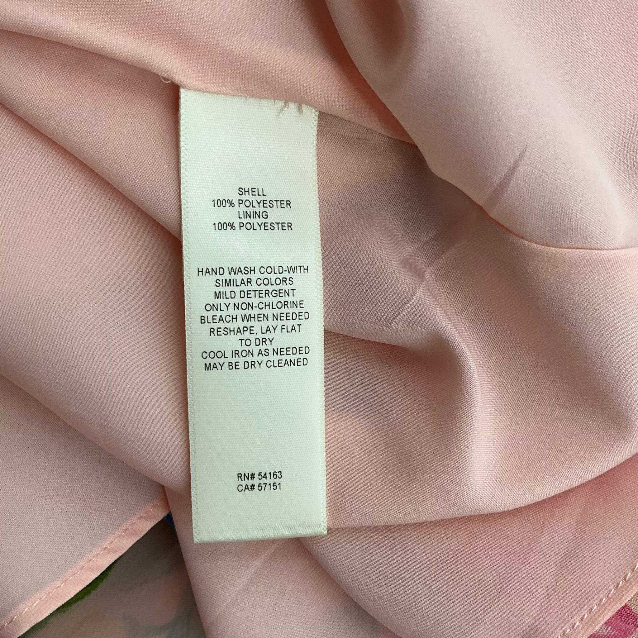 Fabric care label for Eliza J blush floral mini dress, detailing 100% polyester material and care instructions, sold by Margaret’s Fine Consignments.