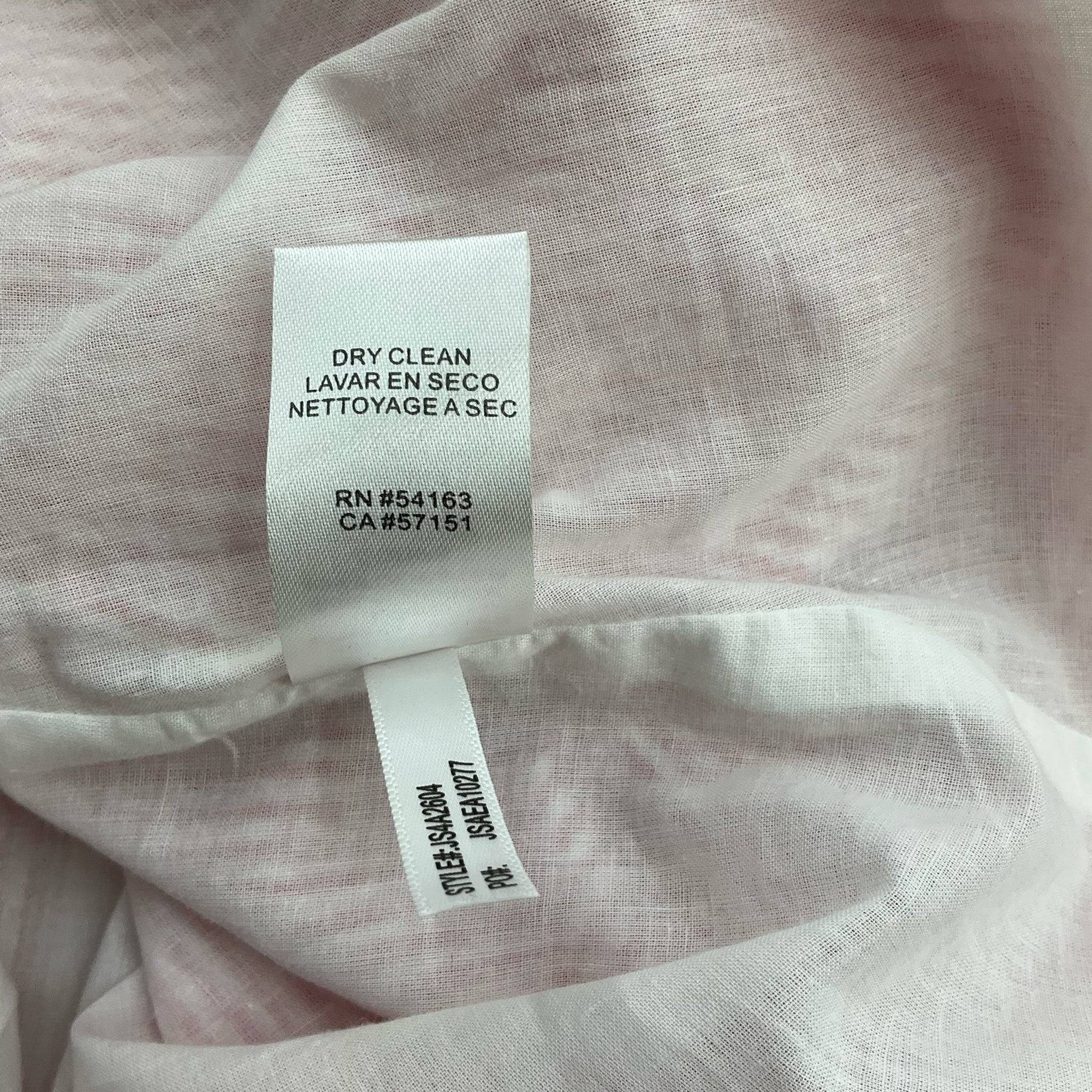 Care label of Jessica Simpson red and white striped dress size 6, indicating dry clean only instructions for garment maintenance.