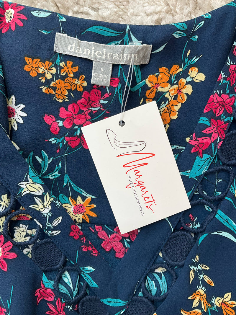 Close-up of Daniel Rainn label and crochet trim detail on Floral Sleeveless Blouse Top Size Small with attached resale tag for sustainable fashion shopping.