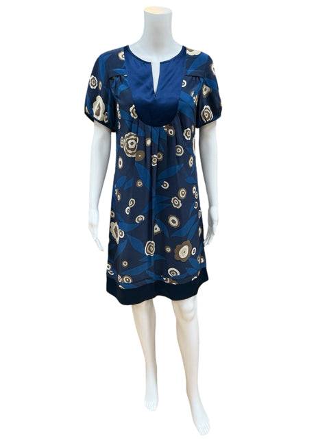 Banana Republic Dress Size Small displayed on mannequin, featuring navy/tan floral print and pleated neckline. Ideal for versatile wardrobe styling.