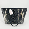 Brahmin Black/Cream Crocodile Purse with dual handles and gold-tone charm, featuring crocodile-embossed leather in a striking black and cream pattern.