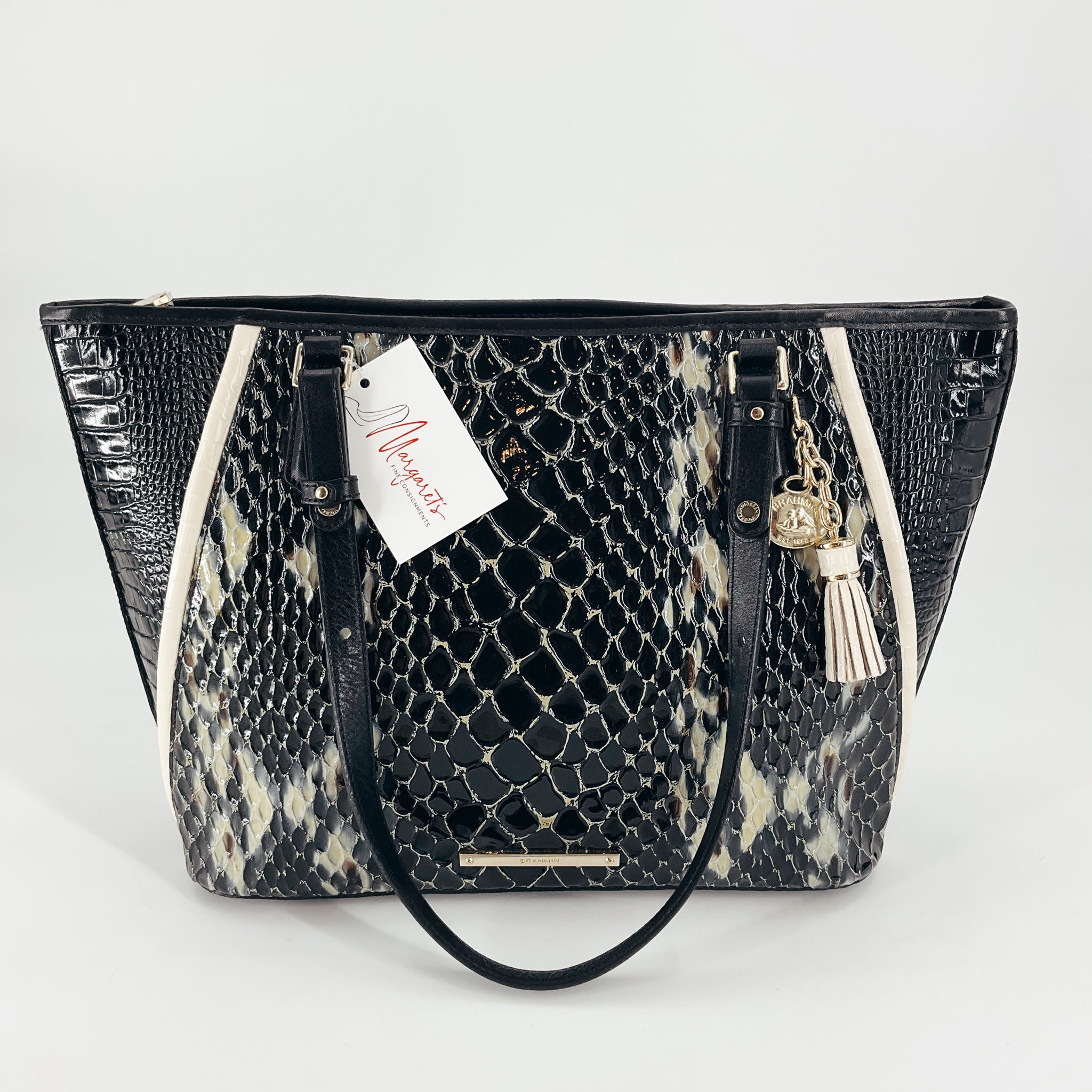 Brahmin Black/Cream Crocodile Purse with dual handles and gold-tone charm, featuring crocodile-embossed leather in a striking black and cream pattern.