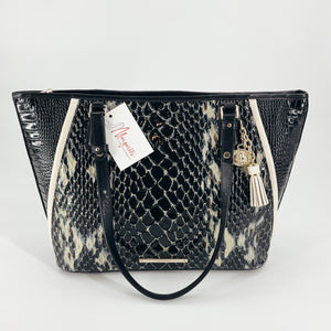 Brahmin Black/Cream Crocodile Purse with dual handles and gold-tone charm, featuring crocodile-embossed leather in a striking black and cream pattern.