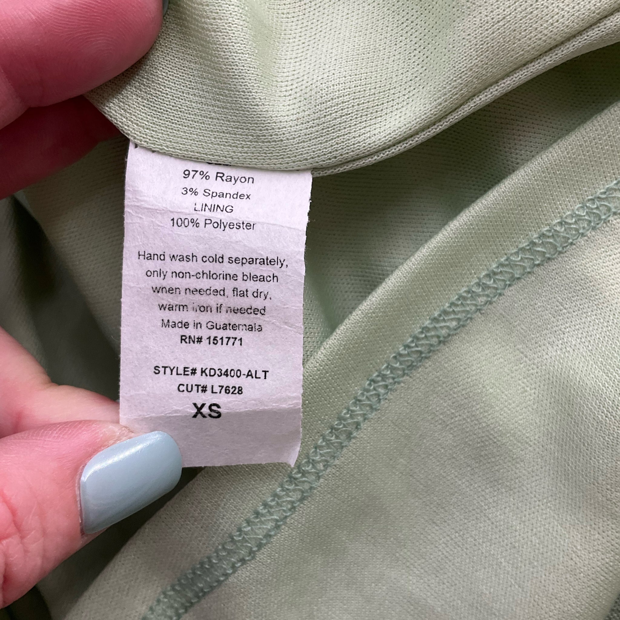 Fabric content and care label of Altar'd State Green Solid Dress - Size XS, made of rayon and spandex, pre-owned and well-maintained.