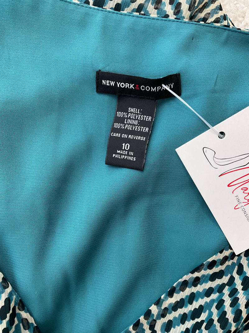Close-up of New York & Co dress label showing size 10, 100% polyester shell and lining, made in Philippines, teal inner lining visible.