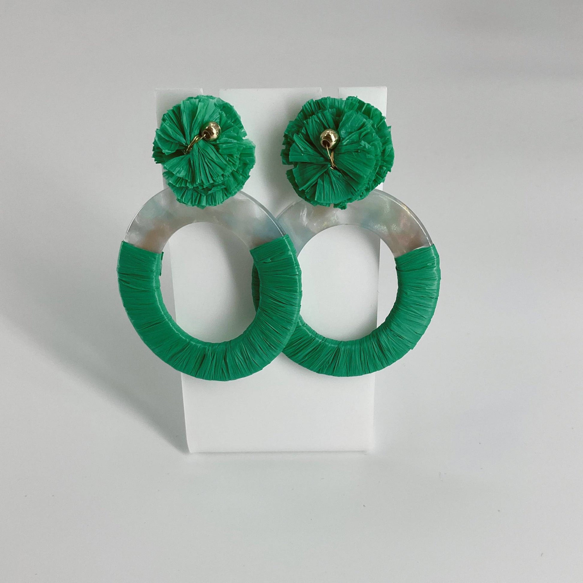 Bold green and white hoop earrings with textured raffia detailing, perfect for statement fashion in the Earrings category.