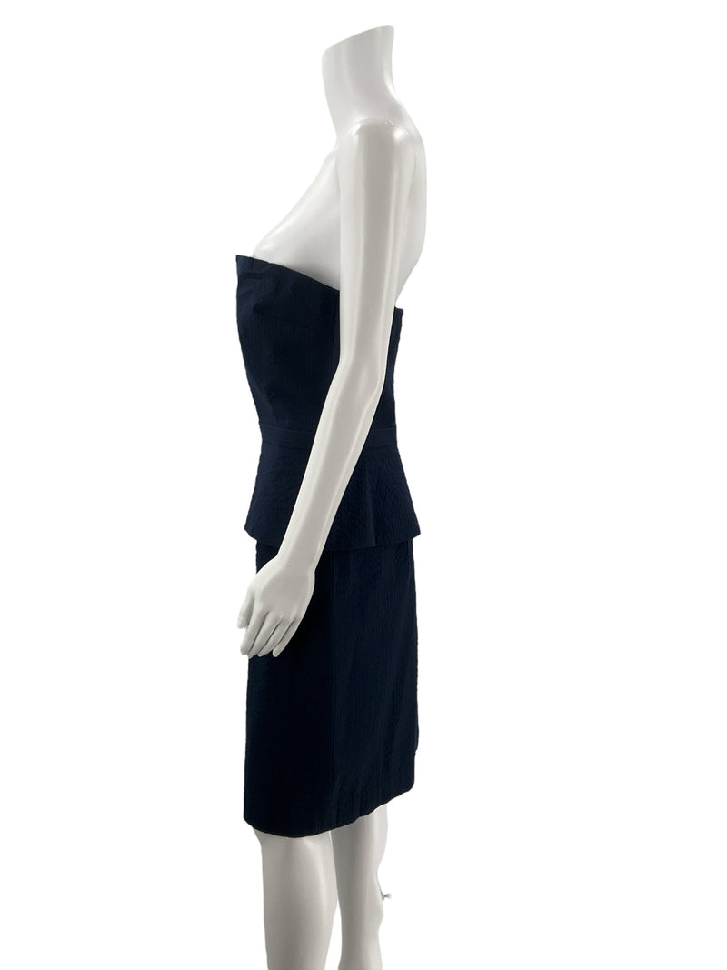 Side profile of Banana Republic navy strapless cocktail dress, size 10, highlighting peplum waist and fitted pencil skirt design.