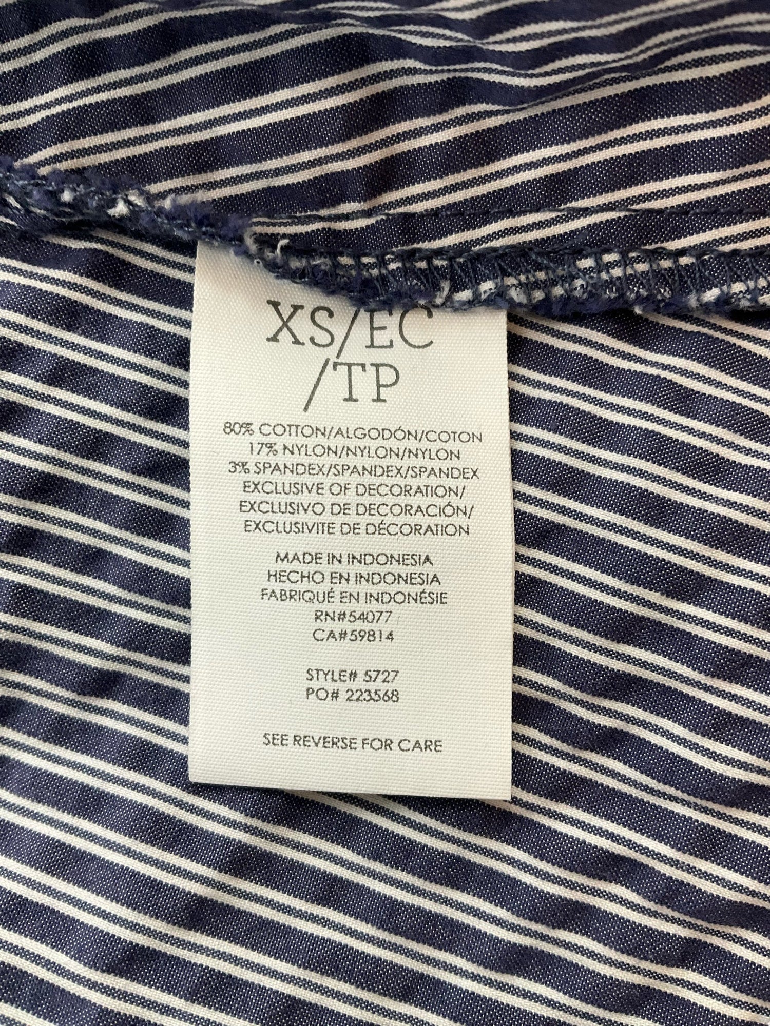 Fabric content tag of Cabi Tapestry Top XS, indicating cotton blend material and style number 5727 with RN 54077.