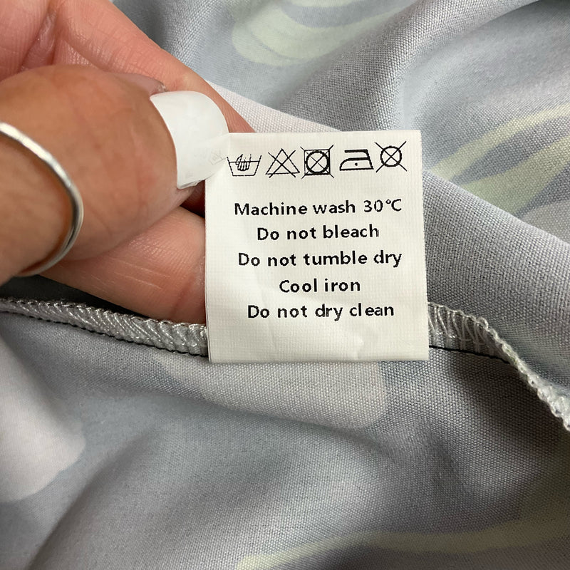 Care label for Uoozee tulip print dress with washing instructions: machine wash 30°C, no bleach, no tumble dry, cool iron, no dry clean.