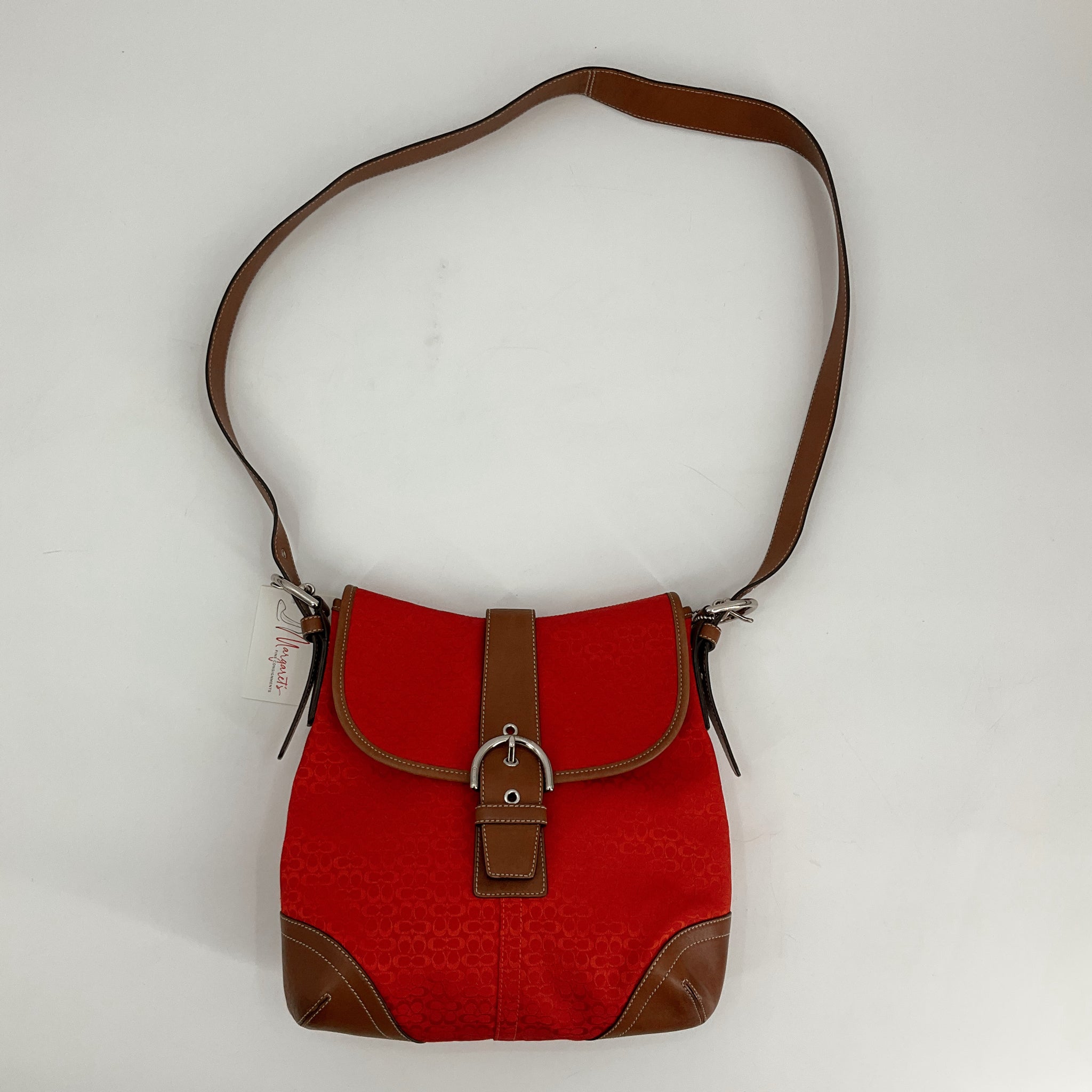 Coach Red/Brown Emblem Crossbody purse with signature C pattern, leather trim, and buckle flap, available pre-owned at Margaret’s Fine Consignments.