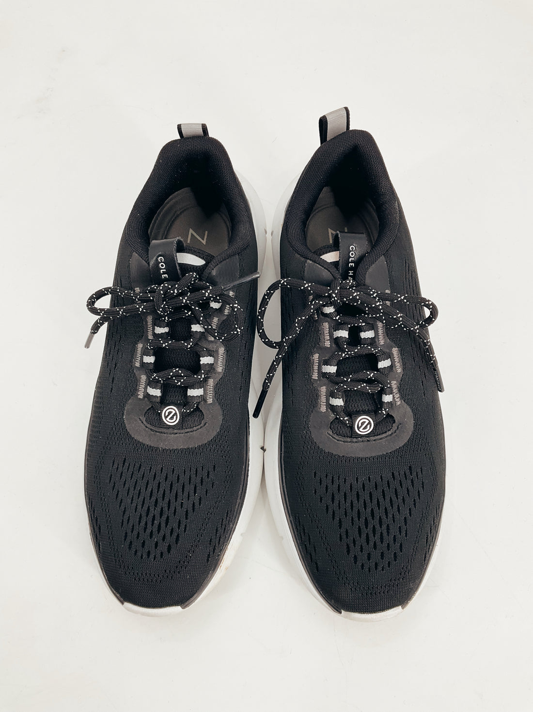 Top view of Cole Haan Black Pre-Owned Ladies Sneakers Size 8 featuring lace-up design and breathable mesh for comfort and style.