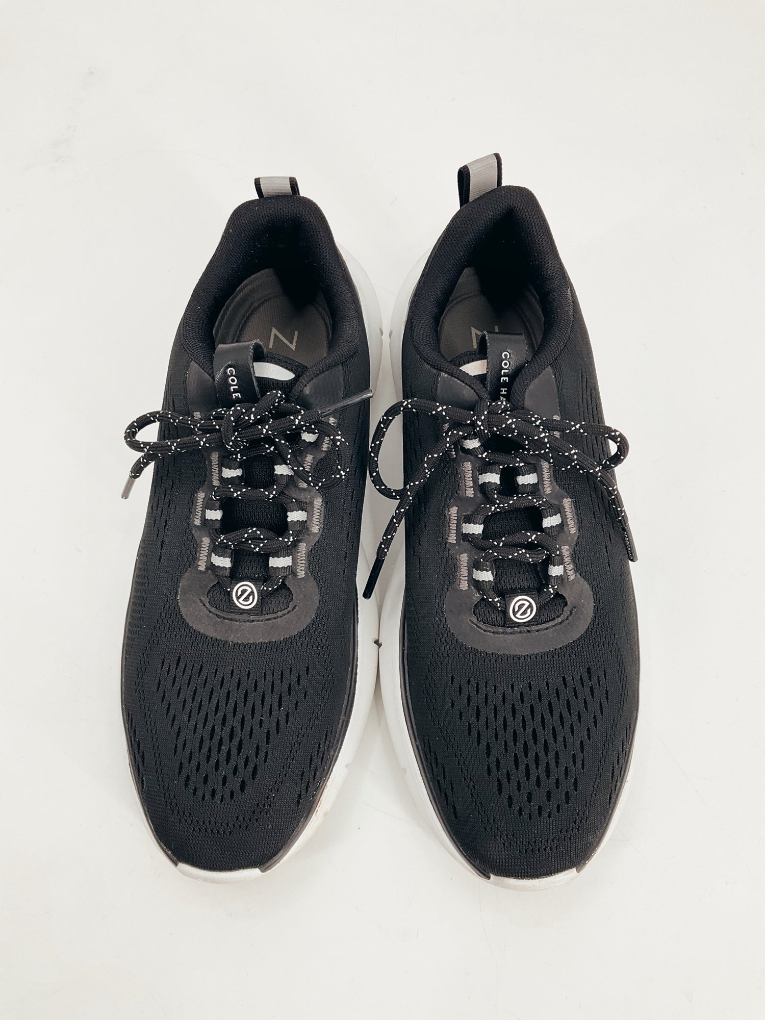 Top view of Cole Haan Black Pre-Owned Ladies Sneakers Size 8 featuring lace-up design and breathable mesh for comfort and style.