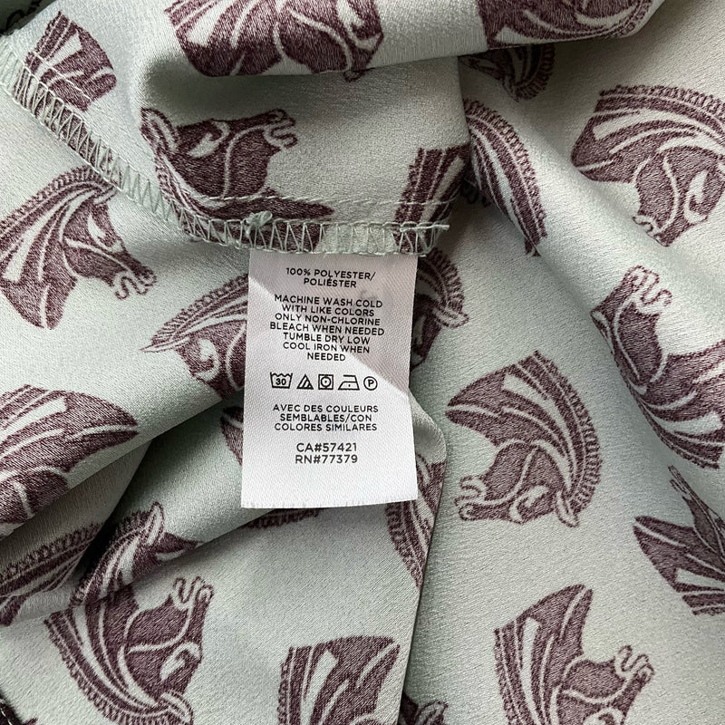 Fabric care label of Ann Taylor Mint/Maroon Pre-Owned Top - Size Large showing 100% polyester material and washing instructions.