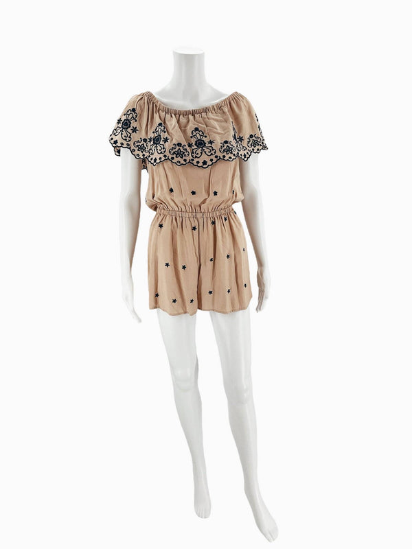 Pre-owned Love Tree Romper in Tan Navy Floral, Size Small, displayed on mannequin with embroidered ruffle detail and elastic waist.