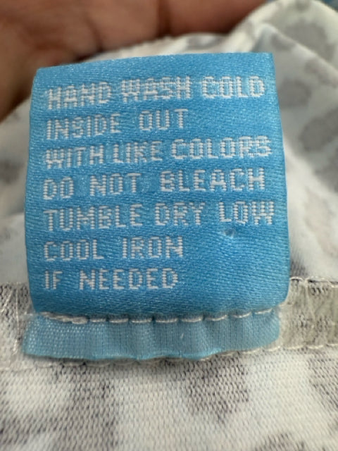 Close-up of care label on J. McLaughlin Catalina Cloth Dress, detailing hand-wash instructions and tumble dry low settings.