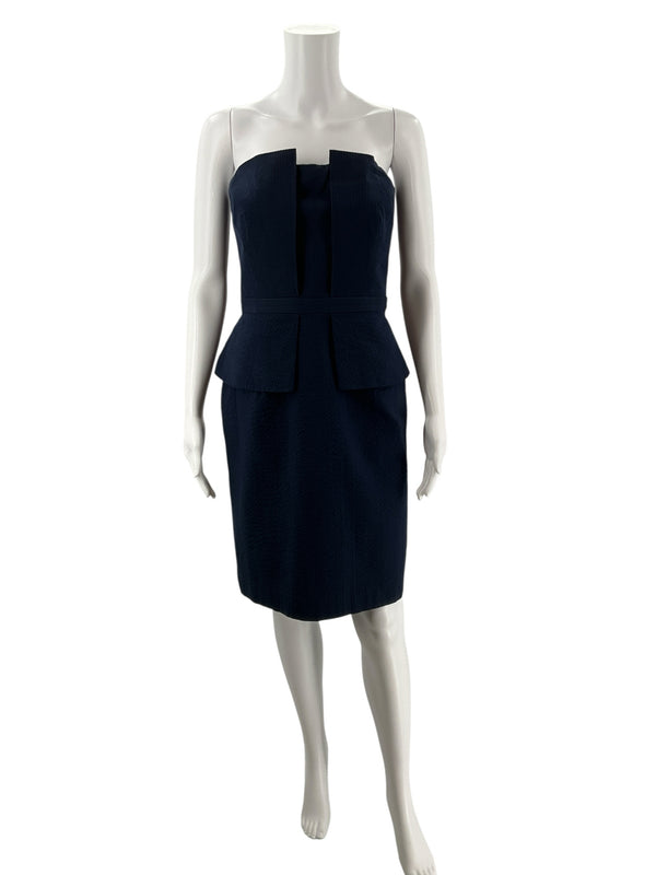 Pre-owned Banana Republic navy strapless peplum pencil dress, size 10, displayed on mannequin with structured bodice and sleek fit.