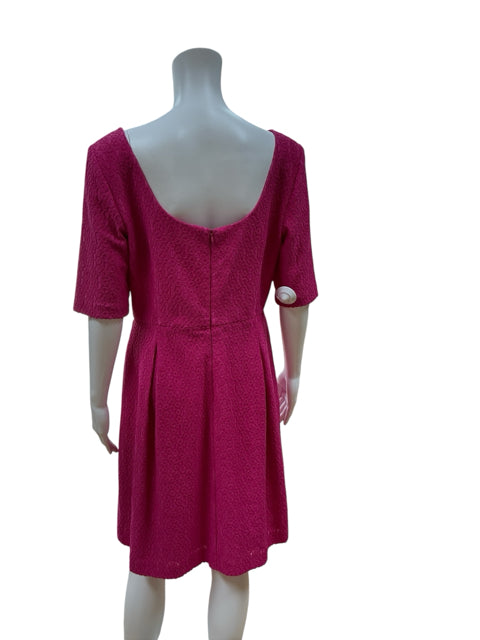 Back view of Trina Turk Pink Textured Pre-Owned Ladies Dress - Size 10, showcasing deep V-back and tailored pleats for a chic party look.