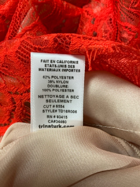 Close-up of care label inside Trina Turk red lace dress, showing fabric composition and dry clean only instructions. Style TD16R006.