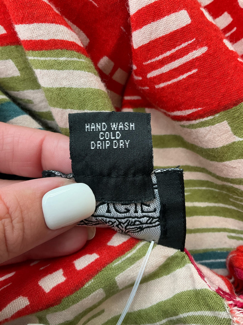 Care label of Angie Tan/Multi Print Dress instructing hand wash cold and drip dry, ensuring proper maintenance of rayon fabric.