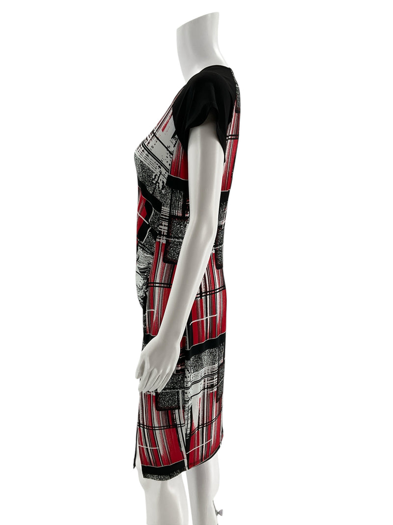 Side profile of Dusak Designs contemporary shift dress with cap sleeves and stretch fabric, showcasing red, black, and white print, size large.