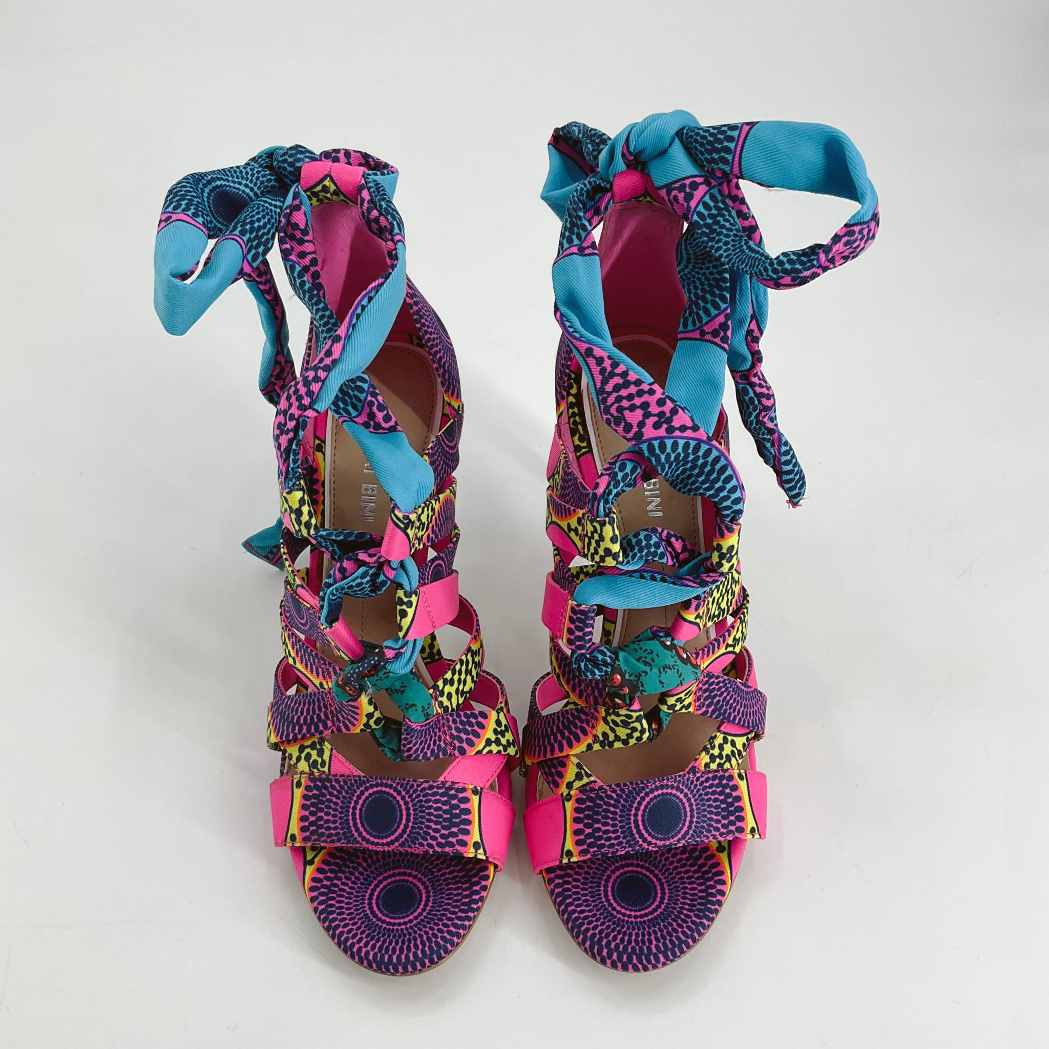 Front view of Gianni Bini Pink/Multi Print Heel - Size 8 showcasing vibrant crisscross straps and colorful ribbon ankle ties, pre-owned and stylish.