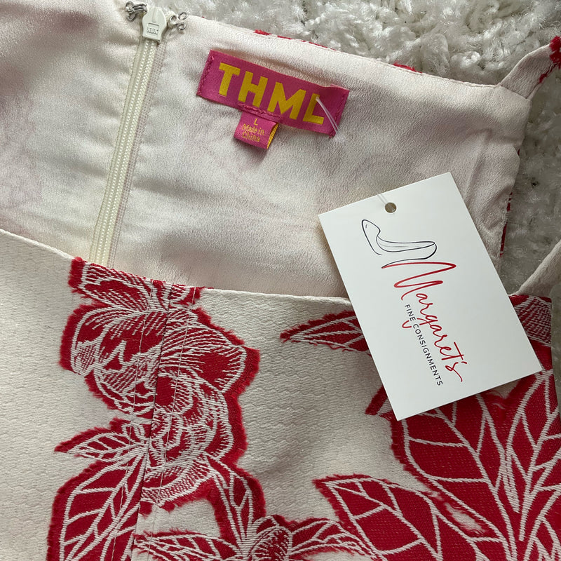 Close-up of THML dress label and Margaret’s resale tag on white/red floral pre-owned dress, size large. Authentic Anthropologie brand.