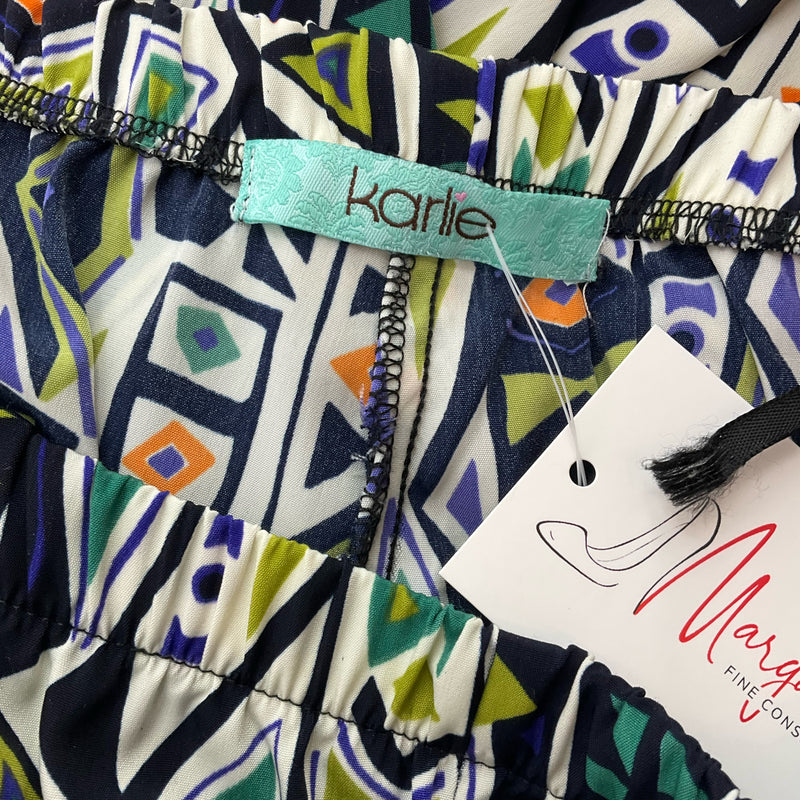 Close-up of Karlie brand label on Cream/Black/Blue Print Pre-Owned Pants, size 6, highlighting elastic waistband and colorful tribal print.