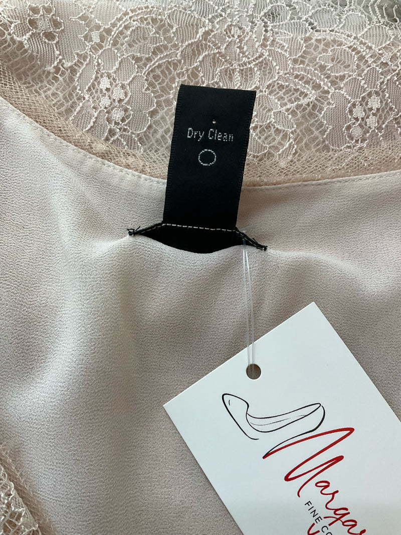 Care label of J Crew Natural Lace Pre-Owned Ladies Top - Size 6 indicating dry clean only instructions, attached to blush lace camisole.