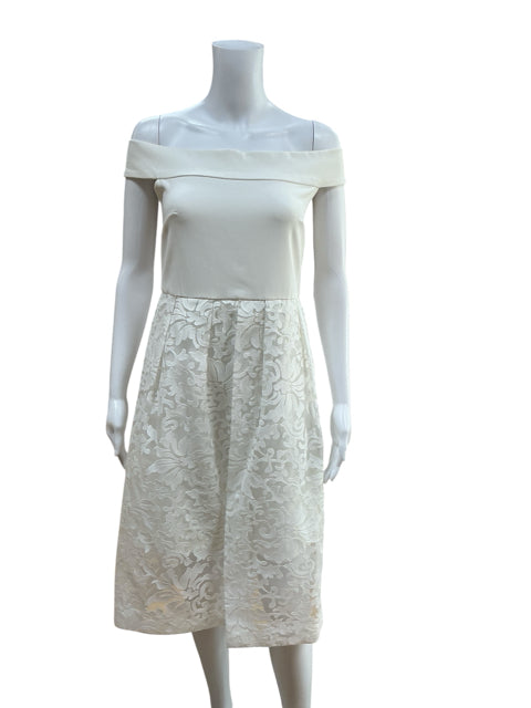 Camilyn Beth white lace pre-owned ladies dress size 6 with off-the-shoulder neckline and floral lace skirt, front view on mannequin.