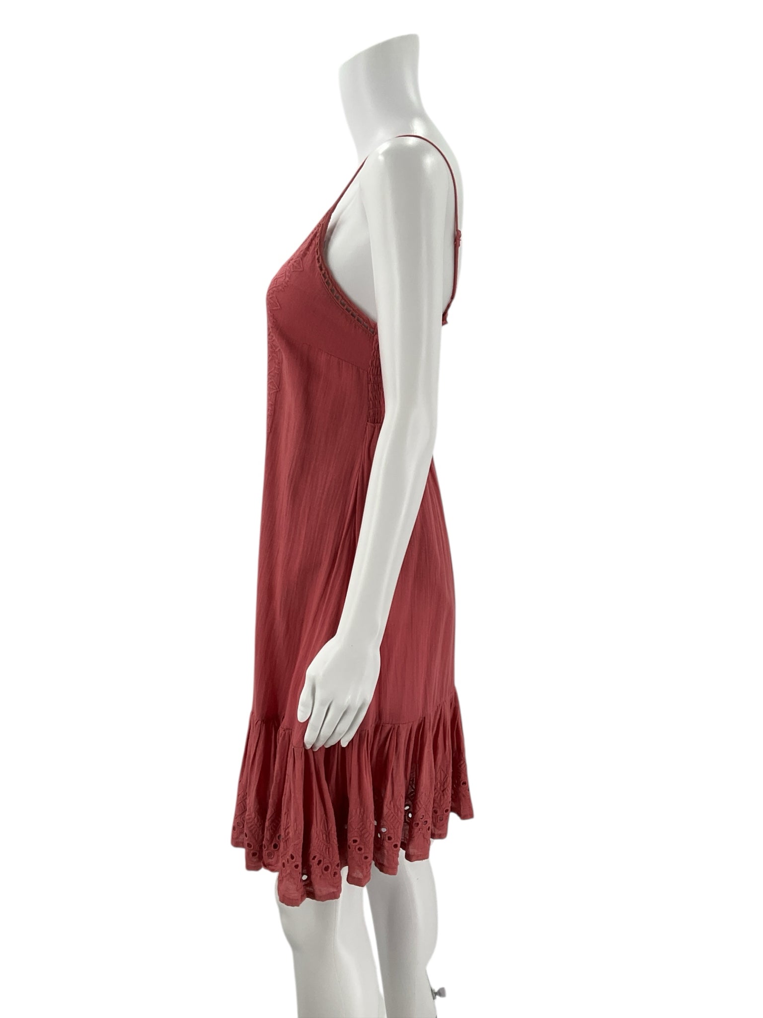 Side profile of House of Harlow Salmon Eyelet Dress - Size XS showing flowy silhouette and eyelet hem, pre-owned and stylish for casual outings