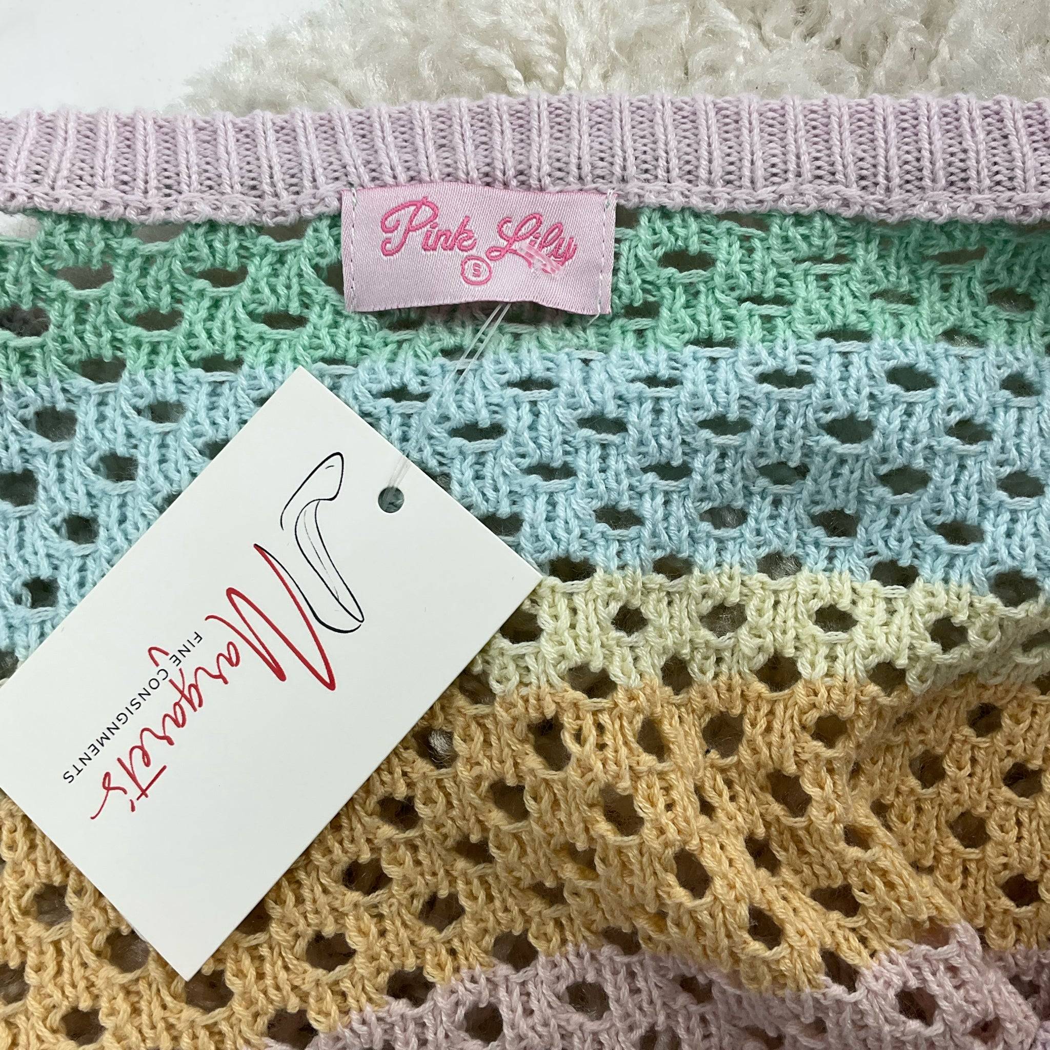 Close-up of Pink Lily brand tag on pastel rainbow sweater, size small, featured at Margaret’s Fine Consignments.