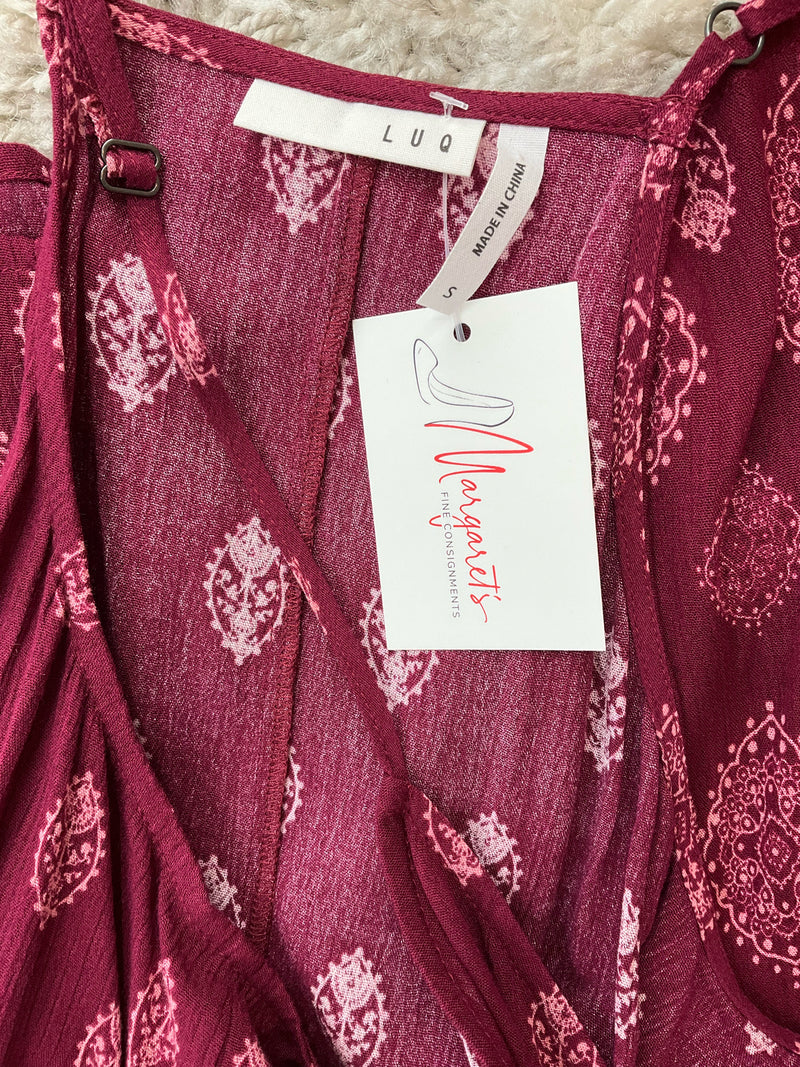 Close-up of Luq brand label and attached tag on maroon/pink boho cami top, confirming pre-owned condition and size small.