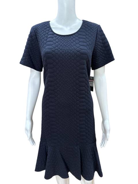 Sharagano Crew Neck Dress Size 10 displayed on mannequin, showcasing navy textured material and ruffled hem, sold by Margaret’s Fine Consignments.