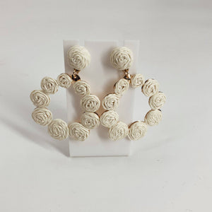 Handcrafted circular hoop earrings with white woven rose detailing, perfect for boho or summer fashion. Earrings from category: Earrings, Item ID: 650069.