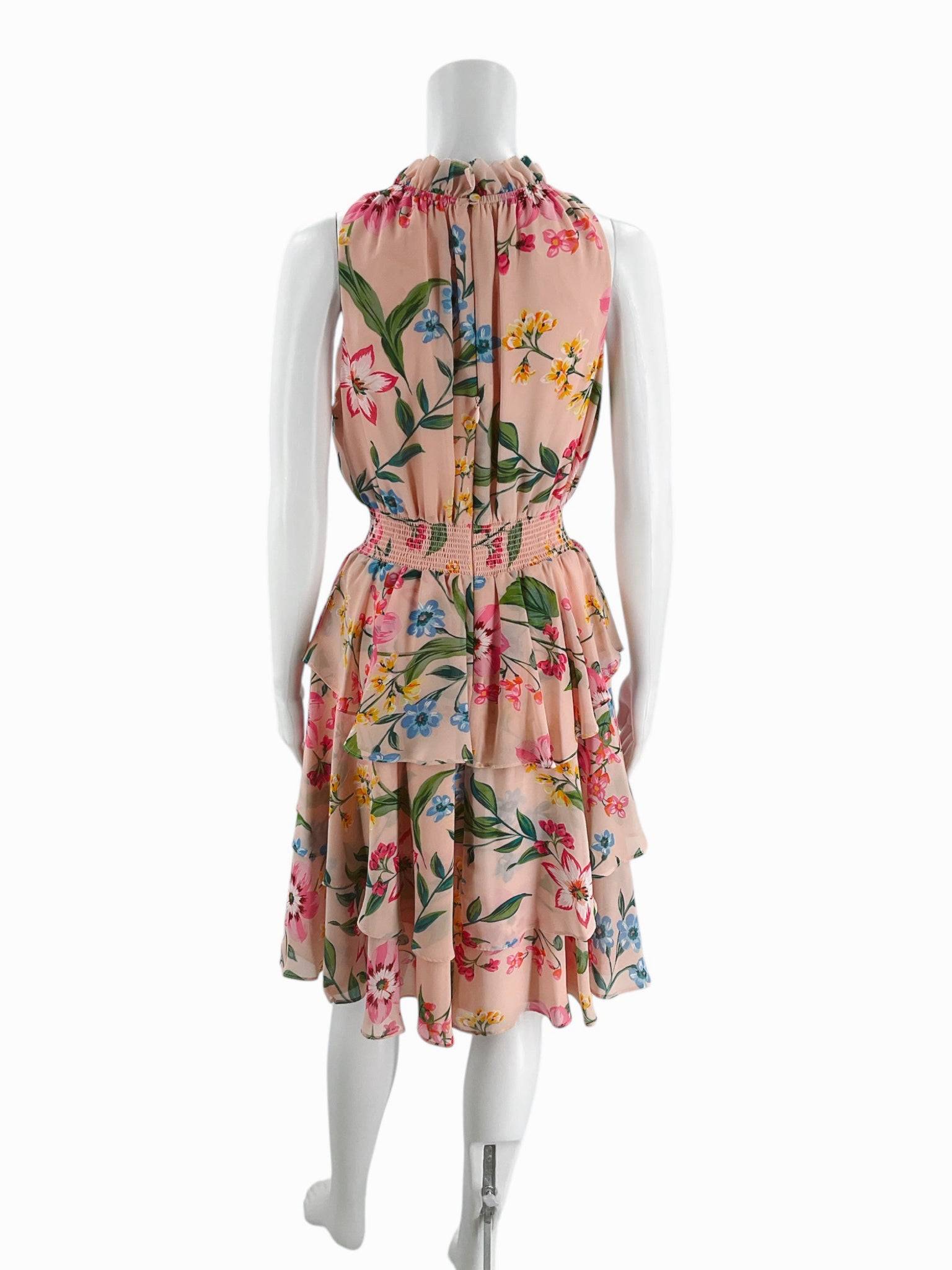 Back view of Eliza J blush floral mini dress size 8 featuring tiered skirt and tie-back neckline, offered by Margaret’s Fine Consignments.