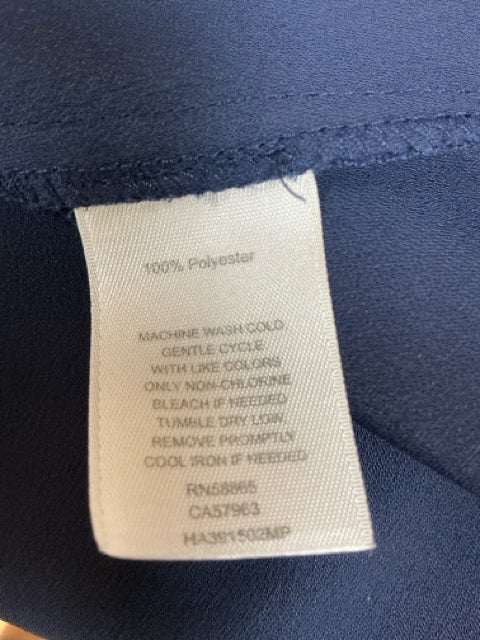 Close-up of care label on Halogen Navy Pre-Owned Ladies Dress - Size XXS Petite, showing 100% polyester fabric and washing instructions.