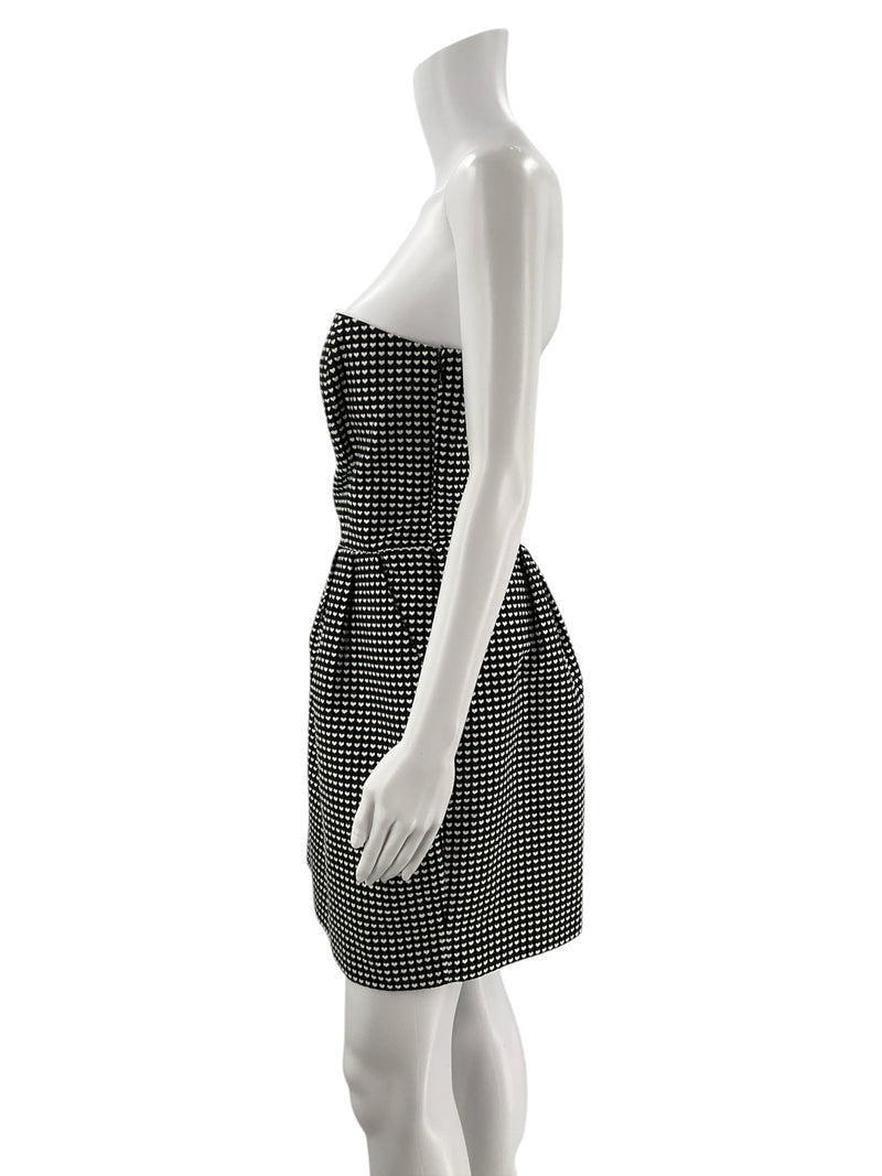 Side profile of Rachel Roy black and white heart jacquard mini dress, showcasing strapless neckline and tailored fit, size 10.