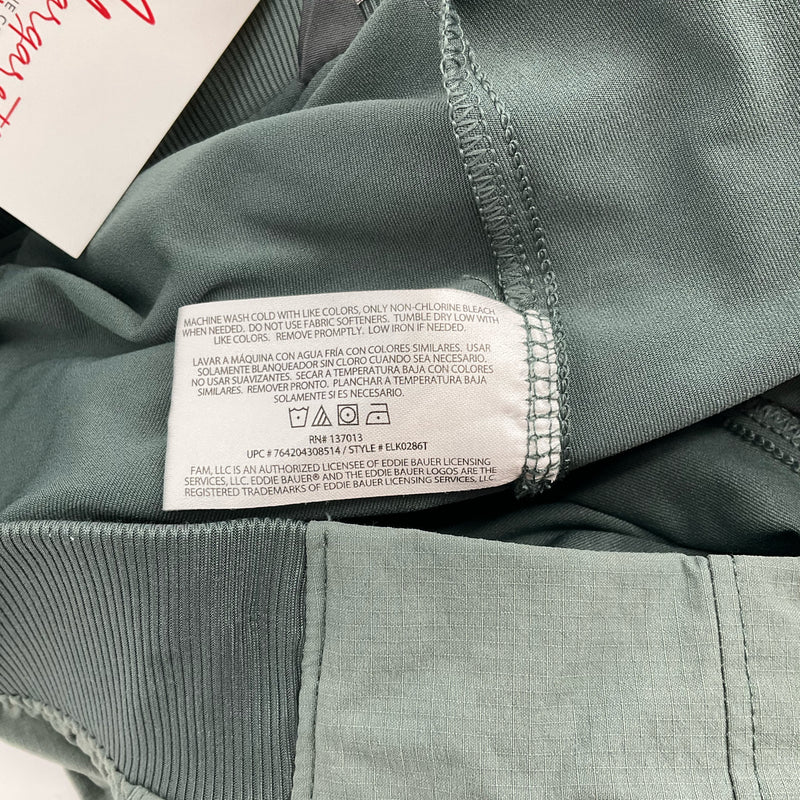 Care label on Eddie Bauer Olive Skort - Size Large showing washing instructions and fabric care details for women's clothing.