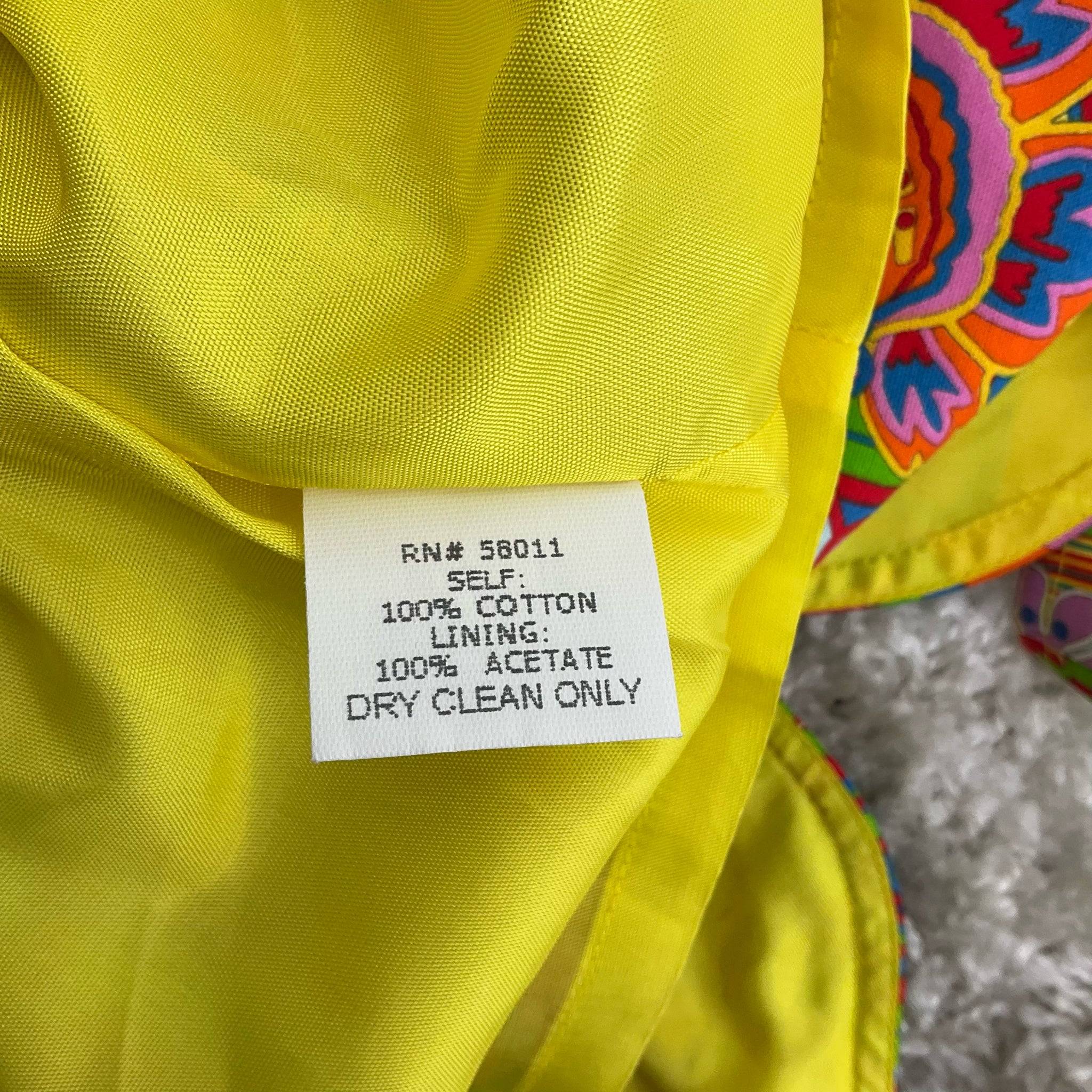 Fabric content and care label of David Meister sleeveless rainbow print dress size 10, 100% cotton with acetate lining, at Margaret’s Fine Consignments.