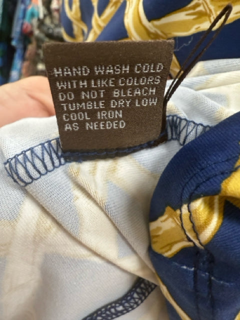 Care label on Jj Mclaughlin Blue/Gold Print Dress indicating hand wash cold, tumble dry low, and cool iron instructions.