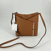 Calvin Klein Tan Solid Purse with sleek crossbody strap and silver-tone accents, NWT, ideal for everyday fashion and functionality.