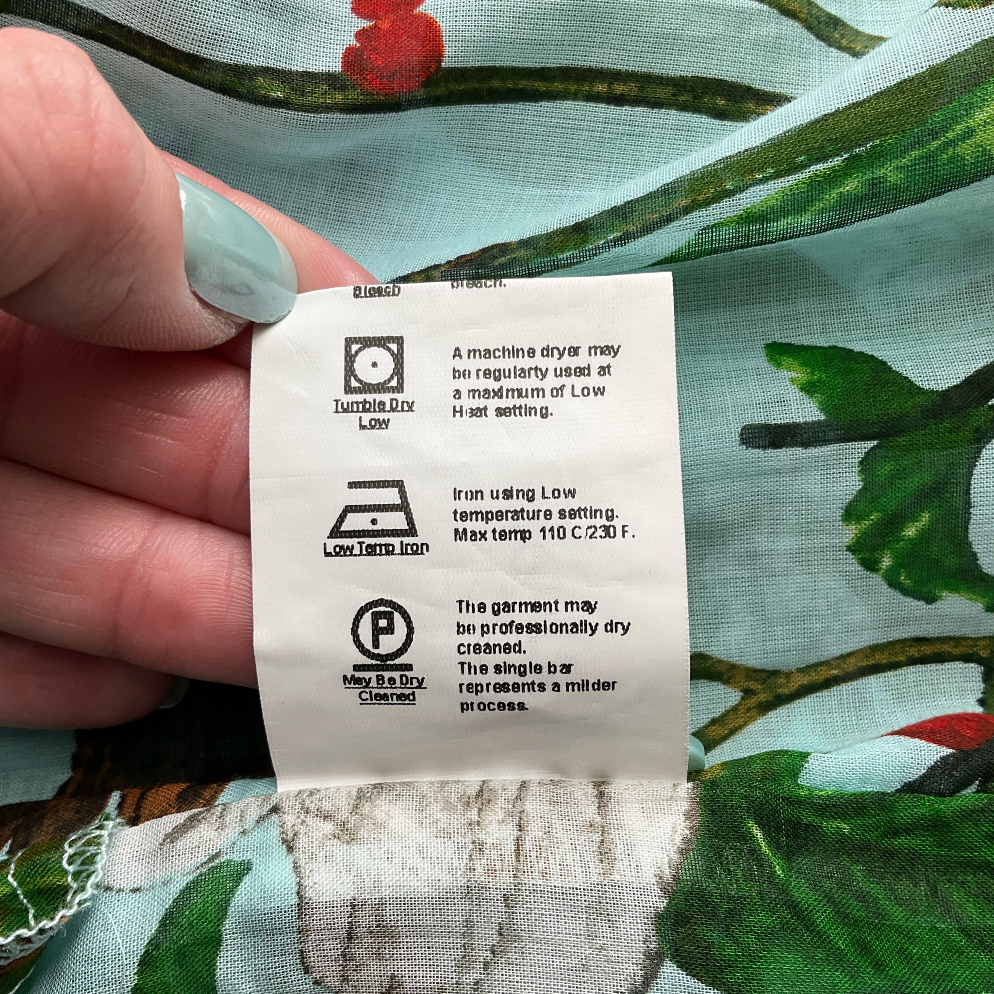 Care label on Samantha Sung Aqua/Green Floral Maxi Dress Size 4 with washing and drying instructions for cotton fabric.