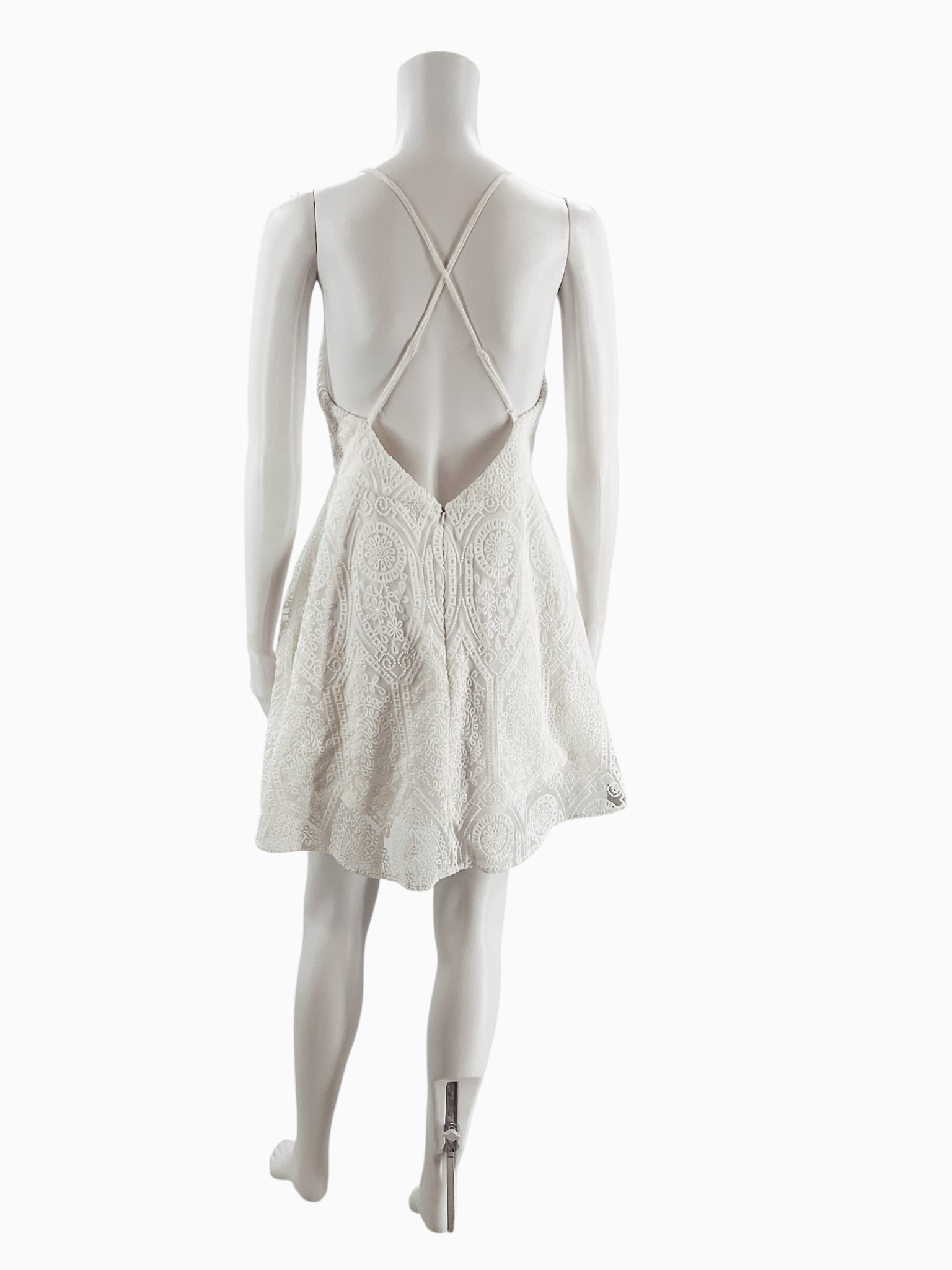 Back view of Illa Illa white lace skater dress showing adjustable crisscross straps and open back design, ideal for summer or cocktail occasions.