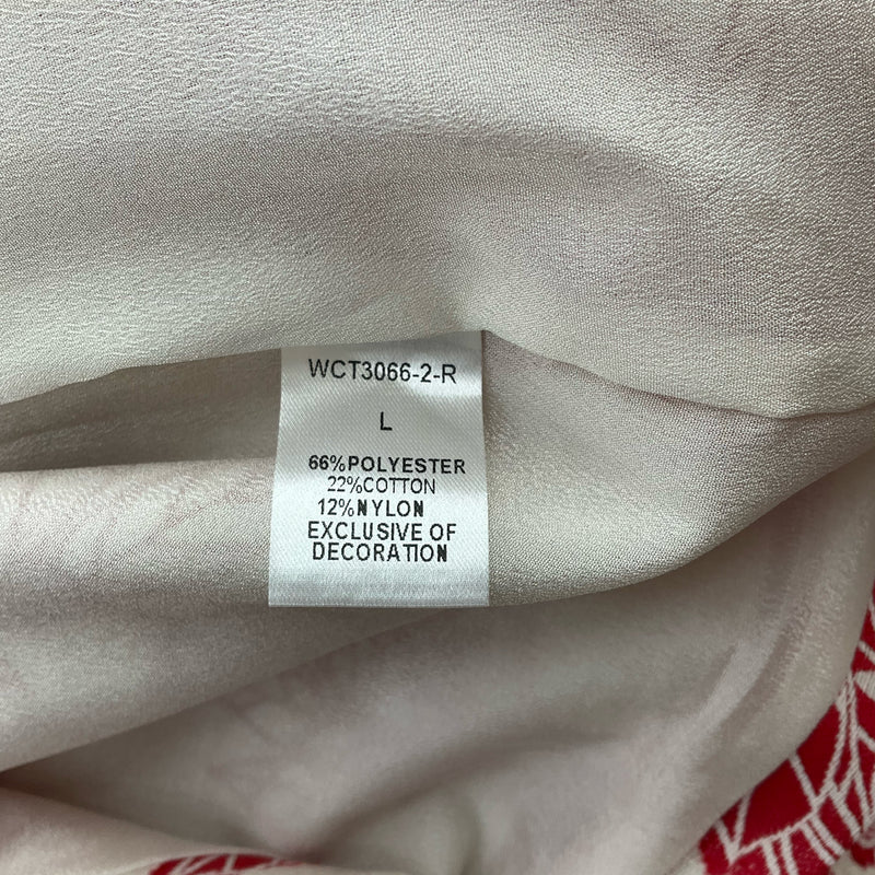 Fabric content tag showing 66% polyester, 22% cotton, 12% nylon on THML white/red floral dress, size large. Pre-owned and well-maintained.