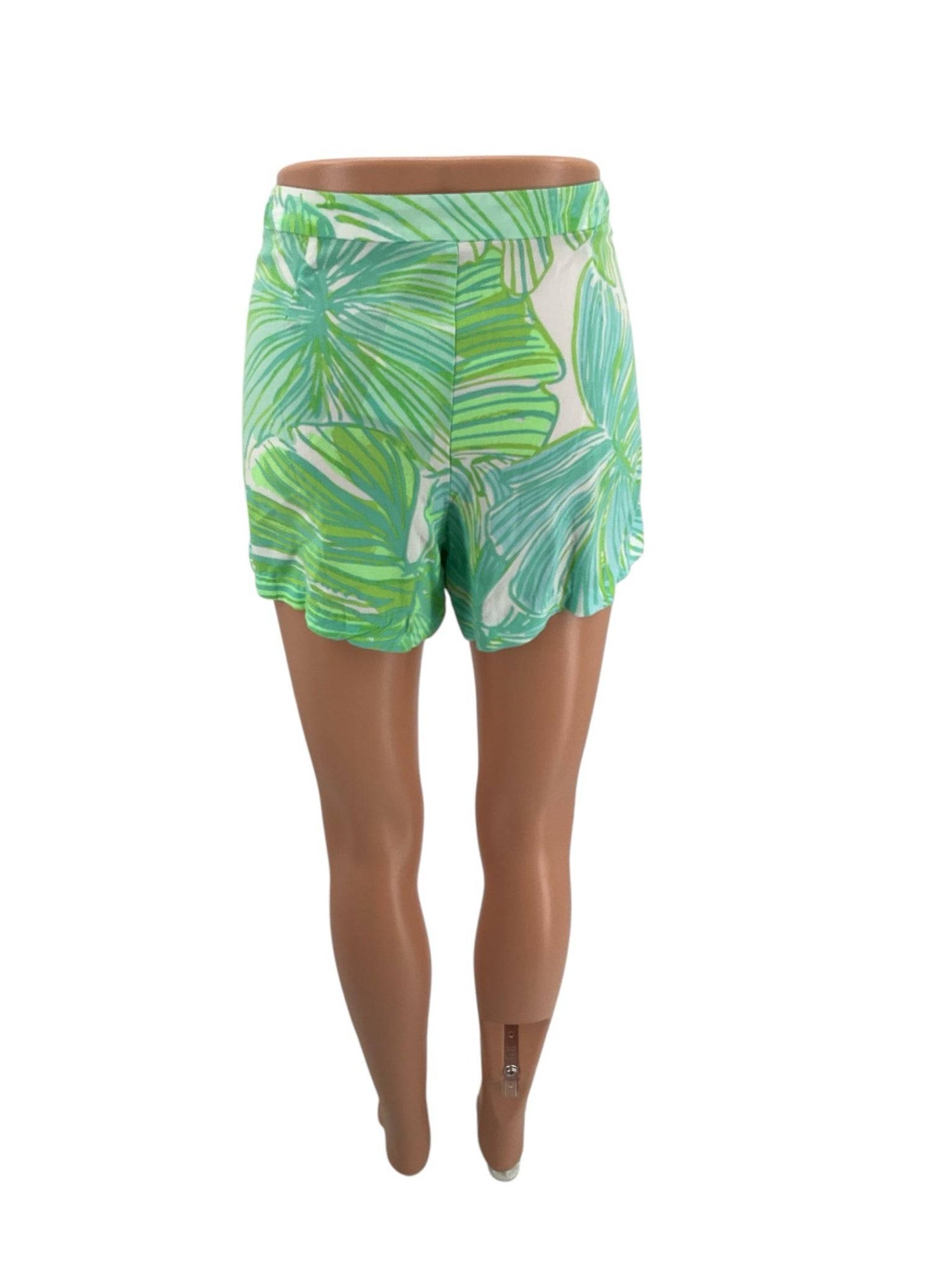 Back view of Lilly Pulitzer Shorts Size 10 with scalloped hem and tropical leaf design in white, green, and blue at Margaret’s Fine Consignments.