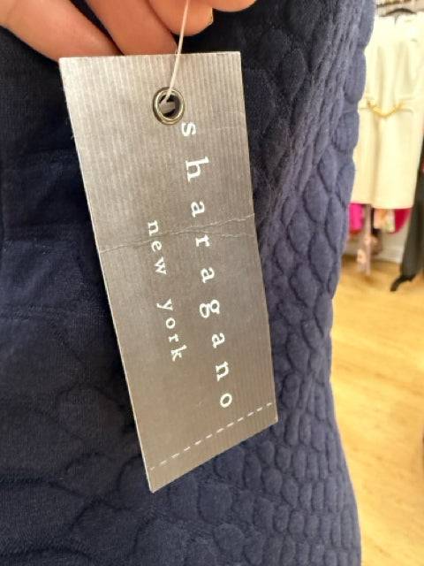 Close-up of Sharagano New York brand tag attached to navy textured Crew Neck Dress Size 10, available at Margaret’s Fine Consignments.