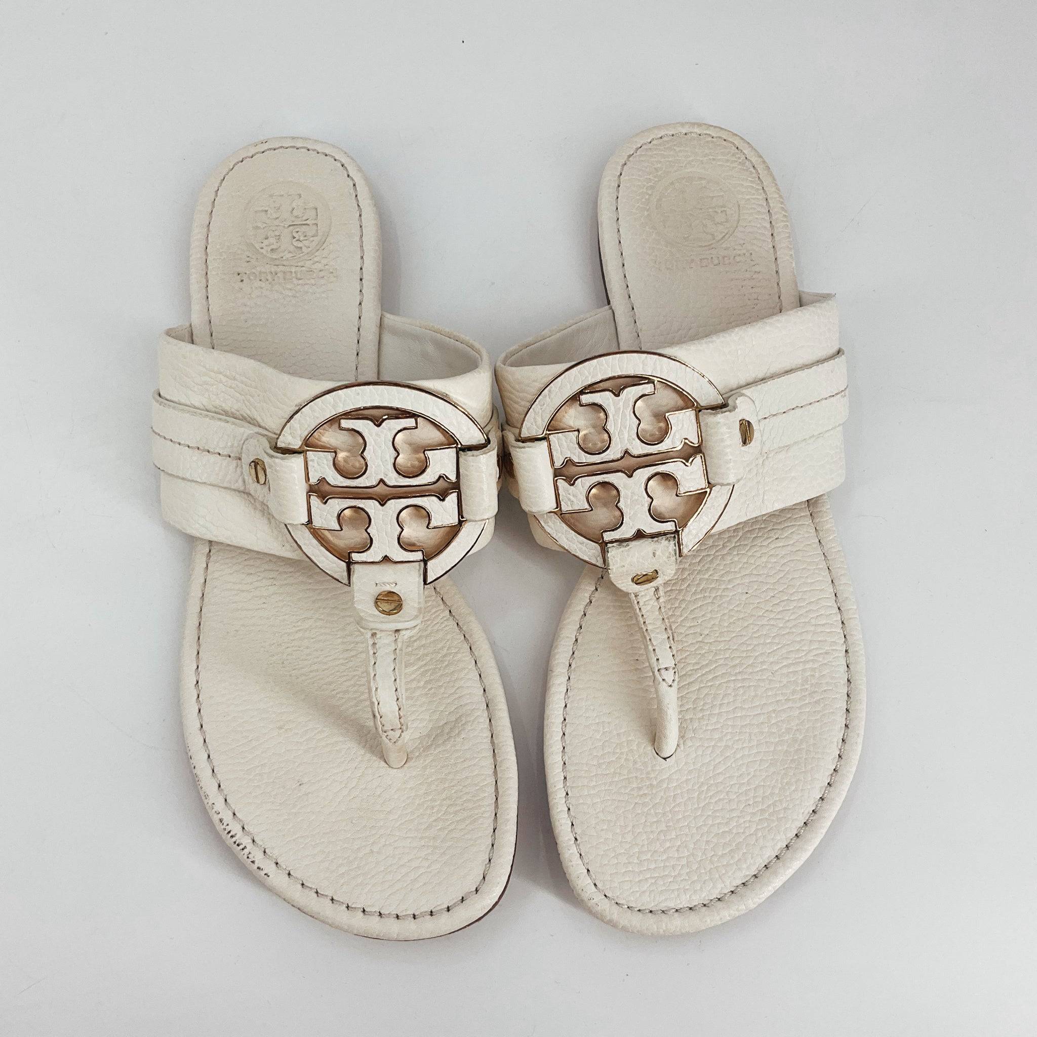 Pre-owned Tory Burch off white flip flops sandals in size 10 featuring signature gold logo and cushioned leather sole for women.
