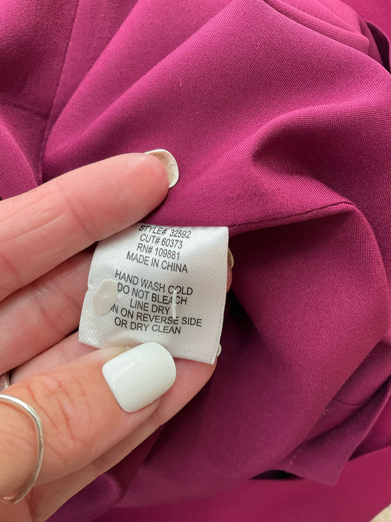 Care label of Oleg Cassini plum dress size 6 with washing instructions and style number 32592, suitable for special occasion or workwear use.