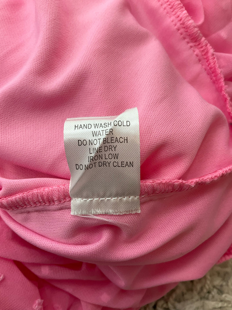 Care label for Favlux Pink Textured Pre-Owned Ladies Dress Size Large instructing hand wash cold, line dry, and no bleach or dry clean.